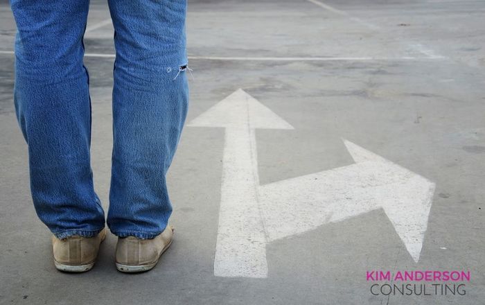 Feet by detour road sign